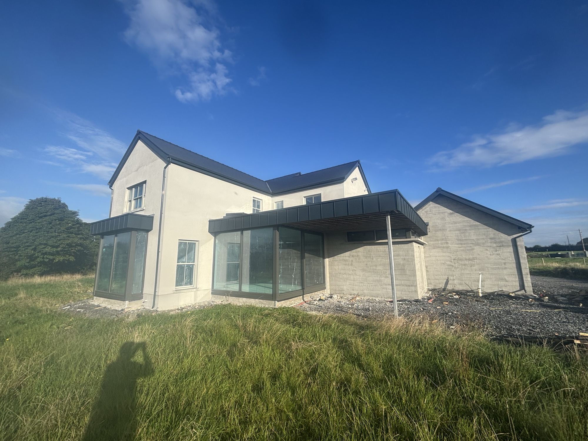 Newly built two-storey house with a glazed corner extension