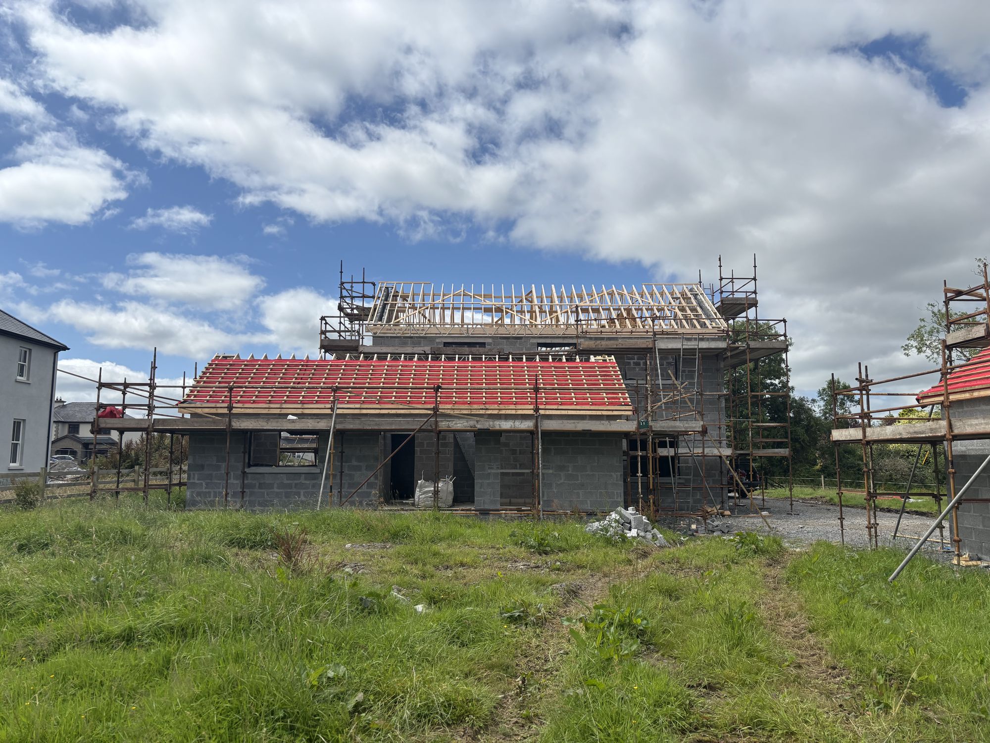 New house under construction with roof structure in place